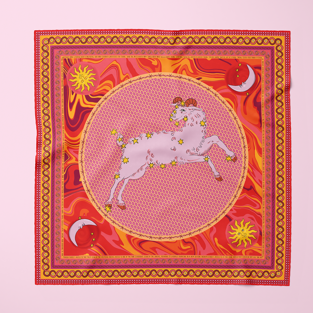 A red and orange silk scarf with sun and moon motifs, a pink and red checkered border, and an Aries ram with constellation on top