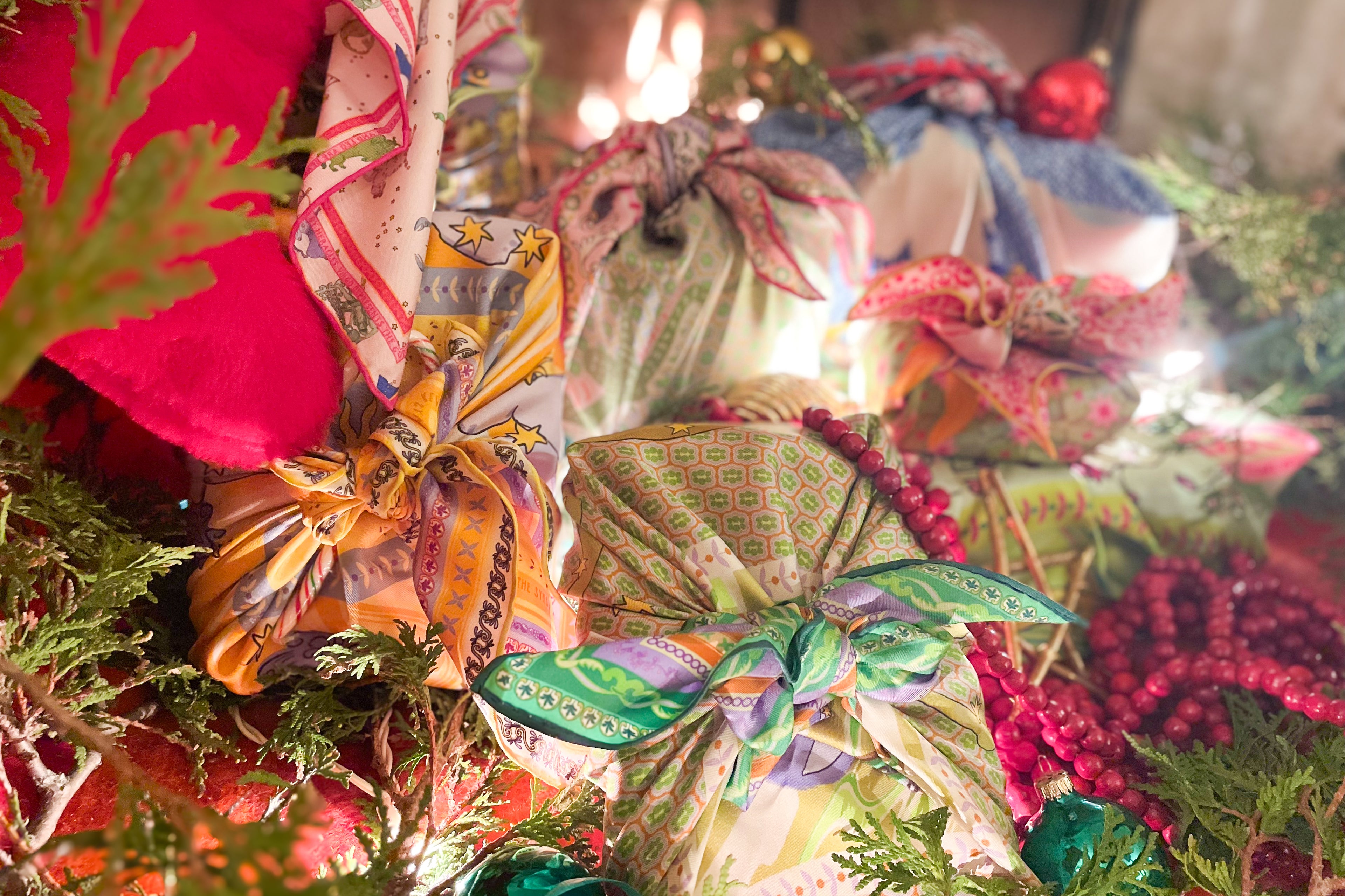 Decorative gift boxes with colorful ribbons and lights on a Christmas tree.